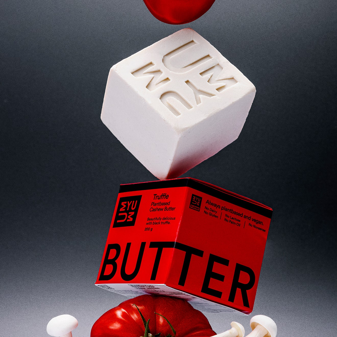 UMYUM Truffle plantbased butter displayed with tomato and mushrooms.