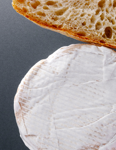 UMYUM Monroe plantbased cheese wheel displayed with artisan bread.