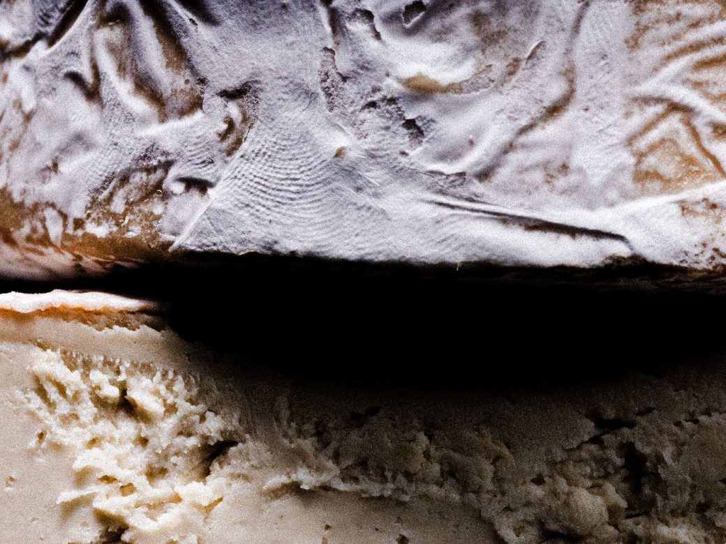 Close-up of the rind and interior texture of UMYUM Monroe plantbased cheese.