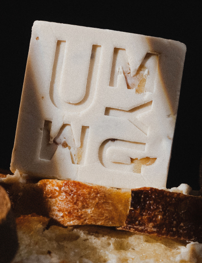 Close-up of UMYUM plantbased butter with artisan bread.